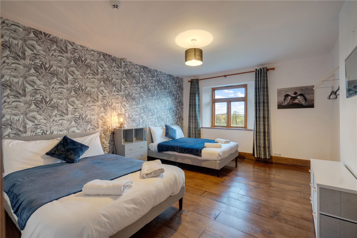 large bedroom with two double beds